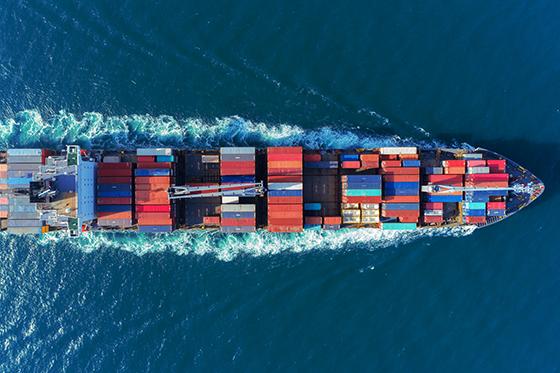 image of colorful container ship coursing through the ocean waves